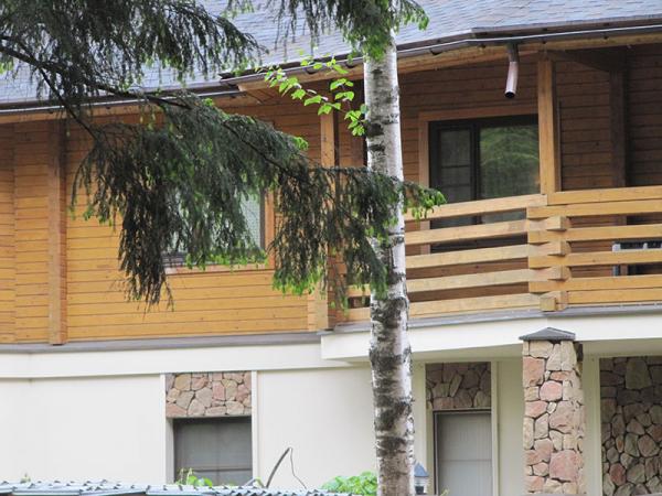 Timber cottage with windows made ??of wood with wooden architraves 1