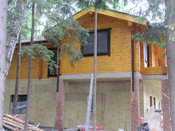 Timber cottage with windows made ??of wood with wooden architraves 3